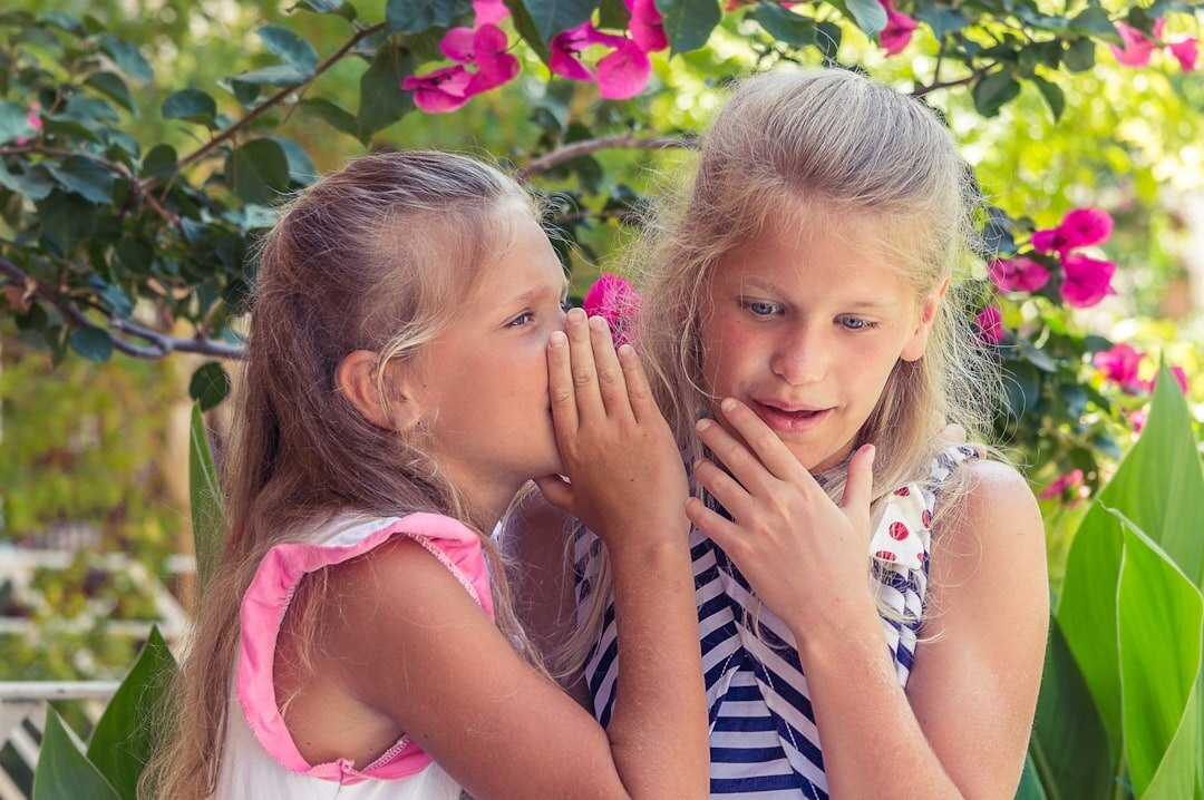 people whispering secrets