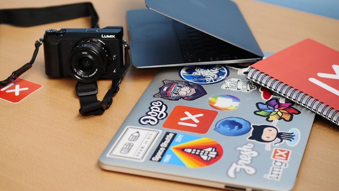 Close-up of a notebook, printed photographs and a laptop used for fact checking